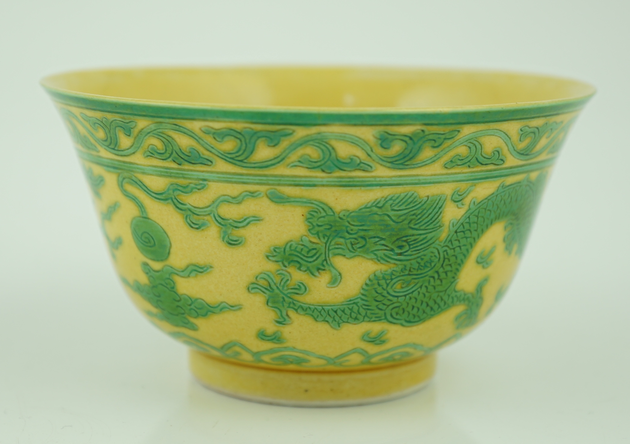 A Chinese green and yellow glazed 'dragon' bowl, Daoguang mark and of the period (1821-50), section of rim broken and restored, hairline cracks